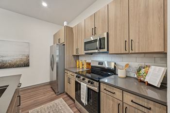 A kitchen with wooden cabinets and stainless steel appliances.